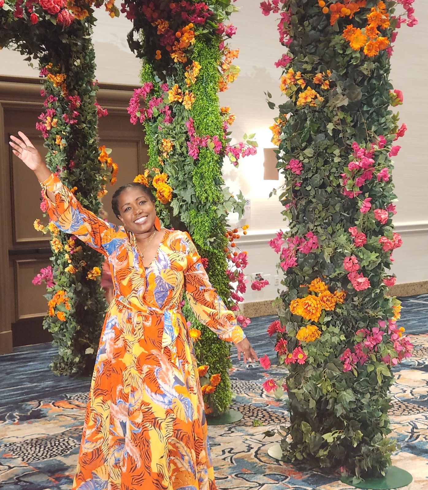 Kommah Koko McDowell in a floral arch